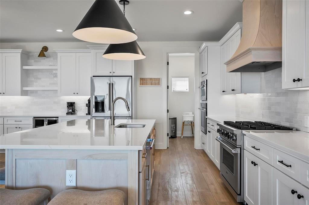 200 Surfview Drive Palm Coast, FL 32137 - Photo 26 of 70 a kitchen with stainless steel appliances granite countertop a sink stove and refrigerator
