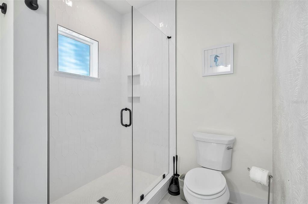 200 Surfview Drive Palm Coast, FL 32137 - Photo 30 of 70 a white toilet sitting next to a bathroom sink