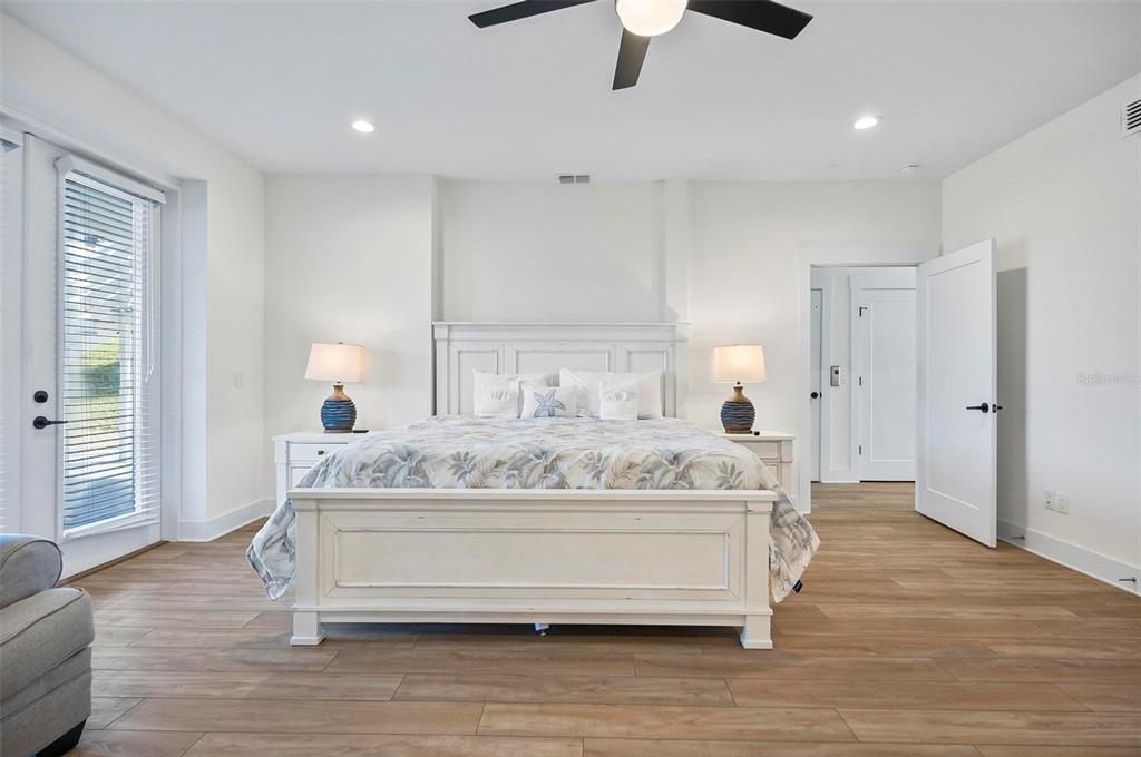 200 Surfview Drive Palm Coast, FL 32137 - Photo 45 of 70 a spacious bedroom with a bed and a chandelier