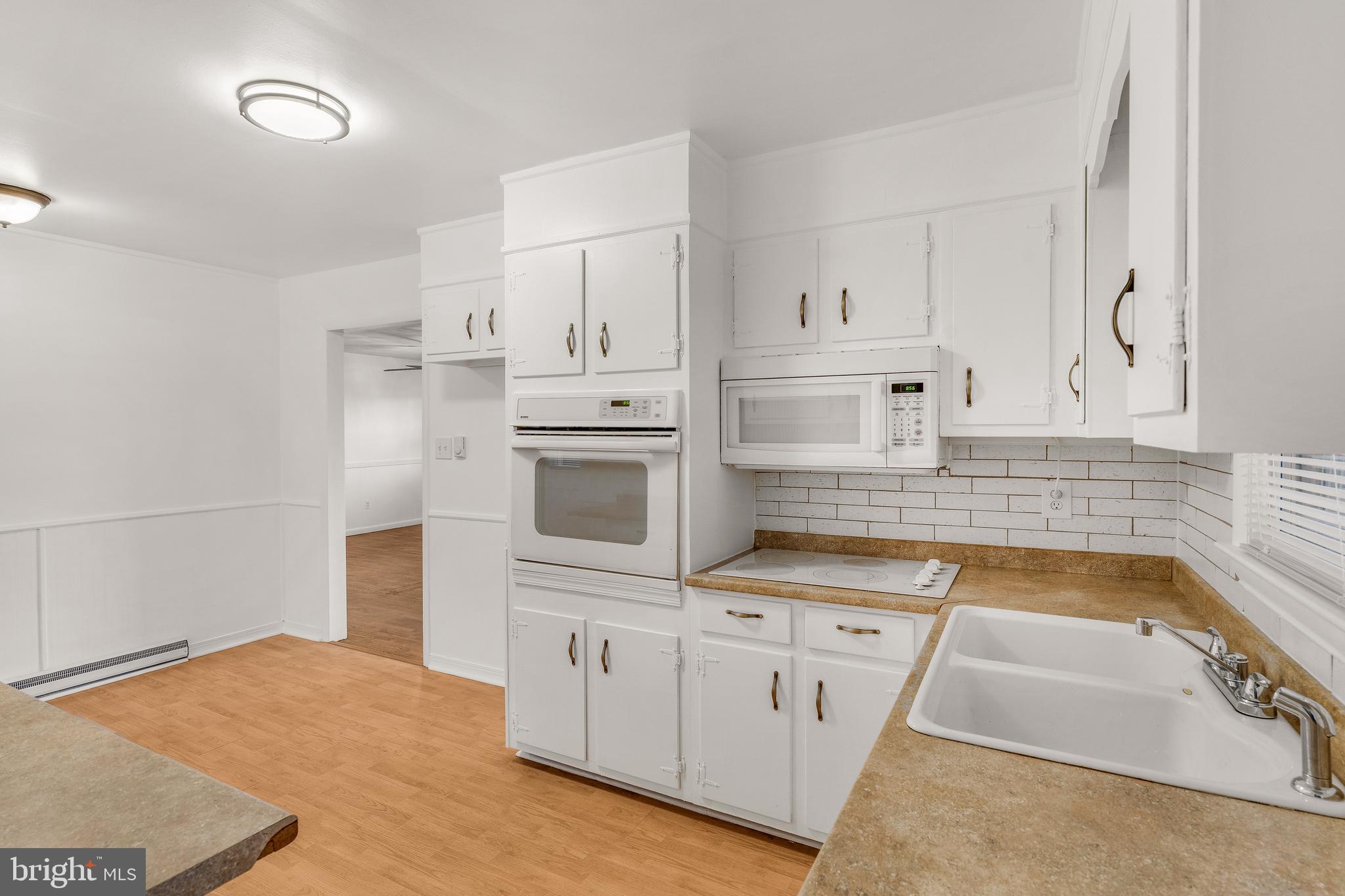 310 North Fairfax Boulevard Ranson, WV 25438 - Photo 17 of 36 a kitchen with white cabinets and sink