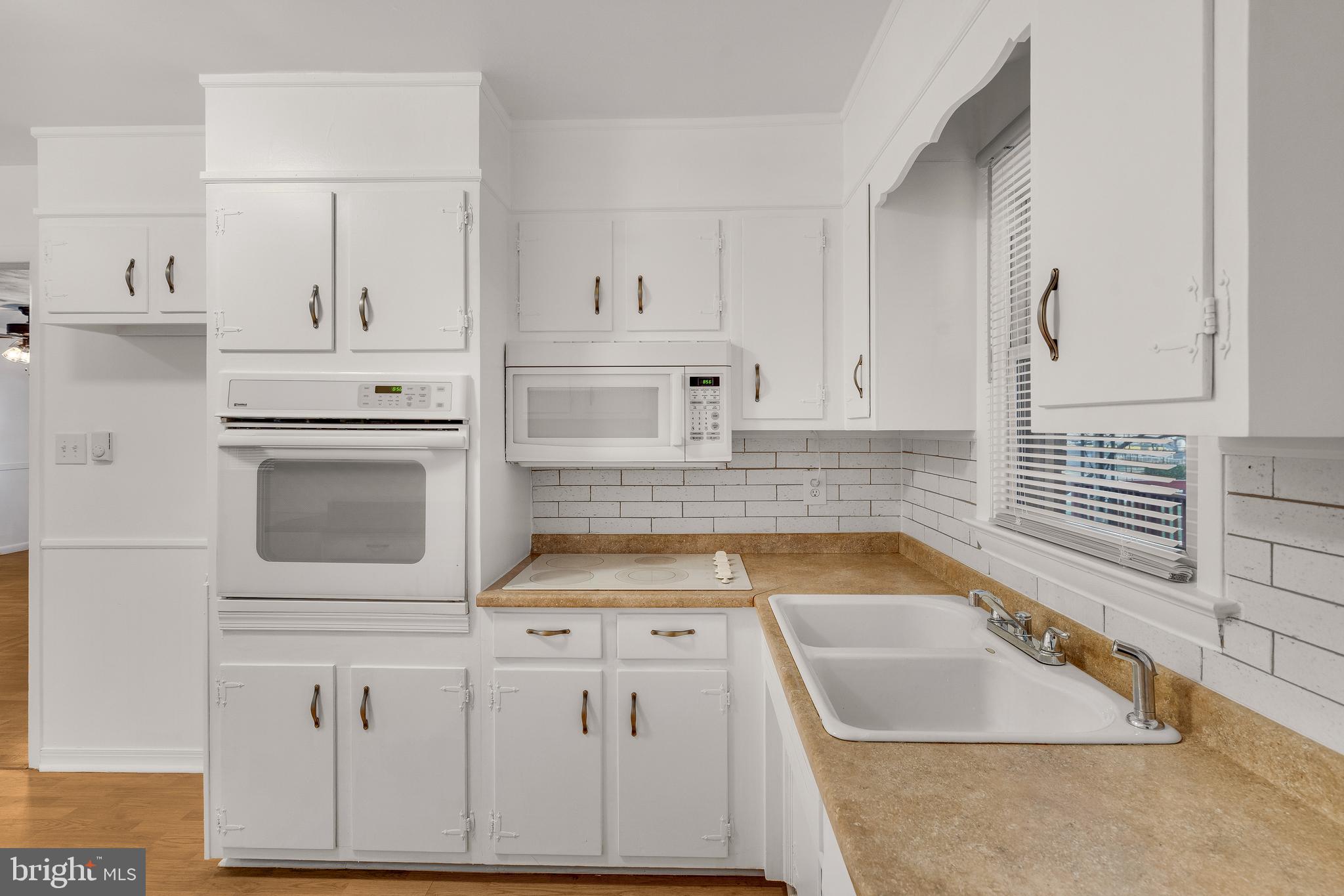 310 North Fairfax Boulevard Ranson, WV 25438 - Photo 18 of 36 a kitchen with white cabinets and white appliances