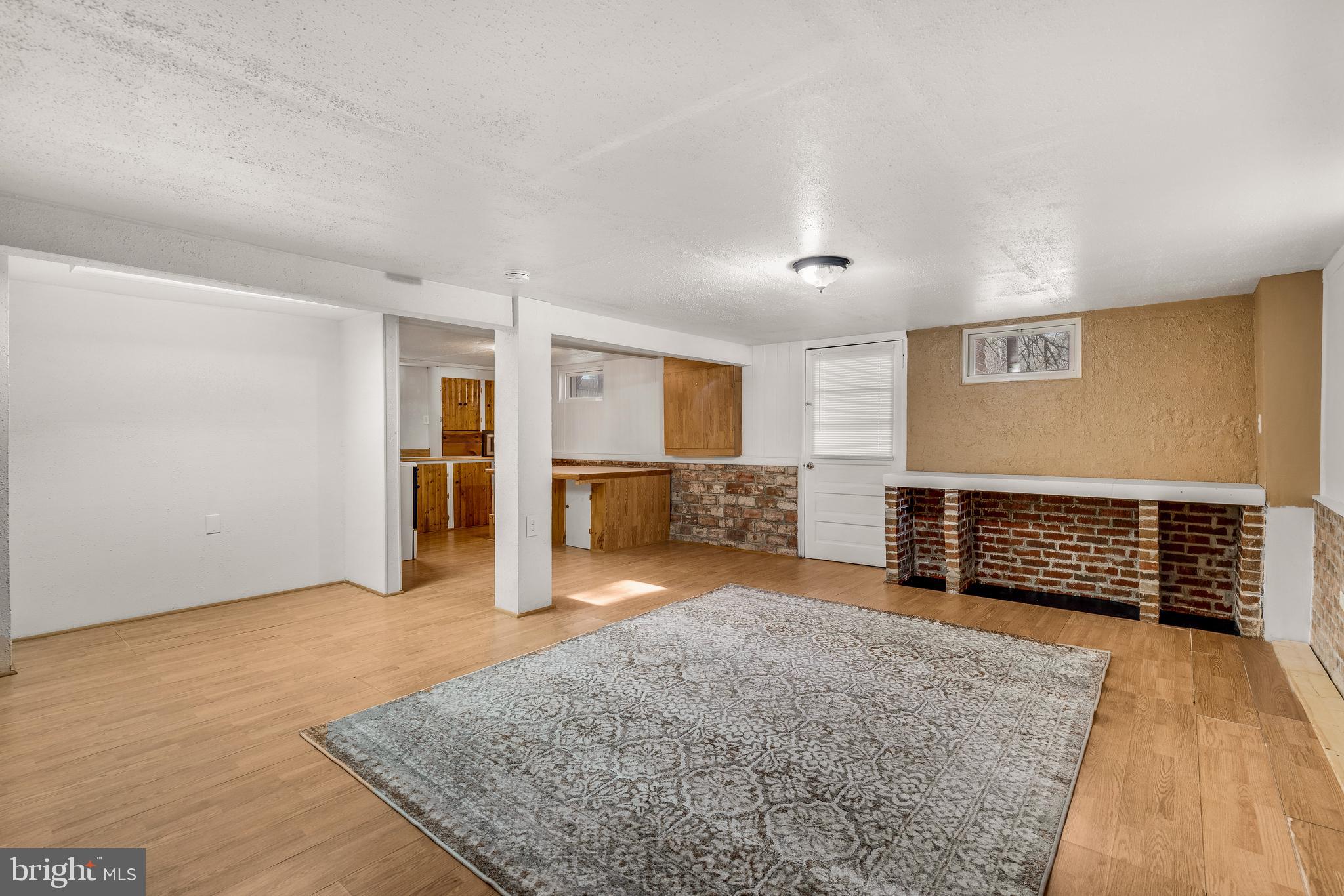 310 North Fairfax Boulevard Ranson, WV 25438 - Photo 31 of 36 wooden floor in an empty room with a fireplace and a window