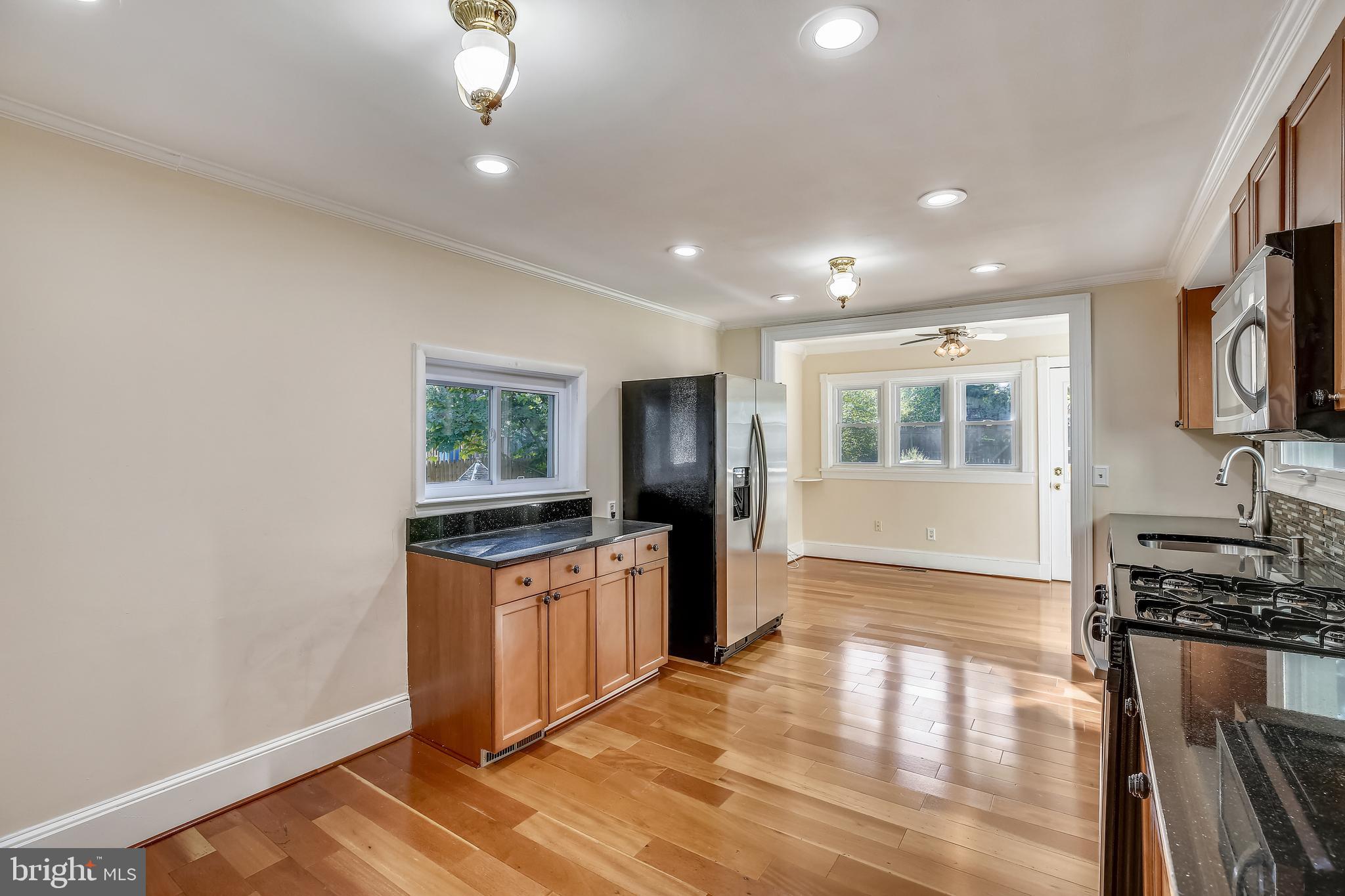 411 Baltimore Road Rockville, MD 20850 - Photo 9 of 48 WARMING hARDWOOD kitCHEN Leads to SunRm/BrkfstRm