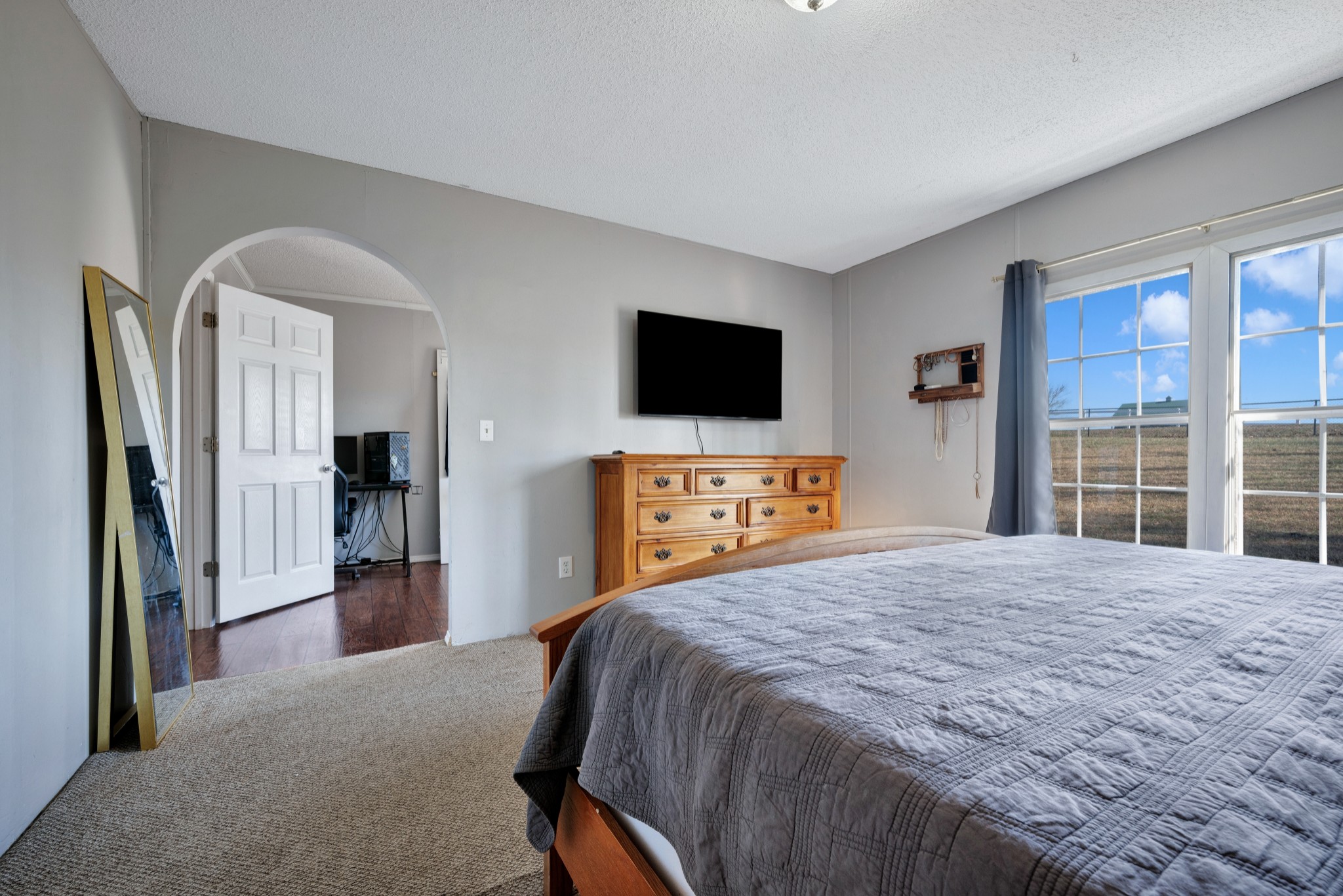 1169 Saddle Tree Road Ashland City, TN 37015 - Photo 12 of 29 a bedroom with a bed and a flat screen tv