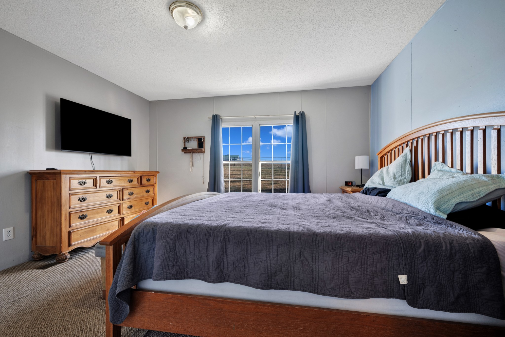 1169 Saddle Tree Road Ashland City, TN 37015 - Photo 13 of 29 a bedroom with a bed and a flat screen television