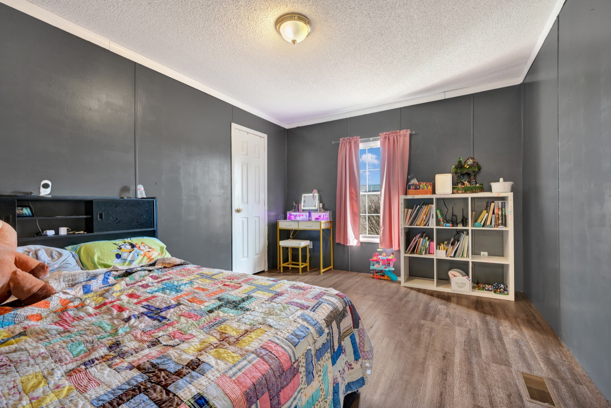 1169 Saddle Tree Road Ashland City, TN 37015 - Photo 17 of 29 a bedroom with a bed and a bookshelf with the wooden floor
