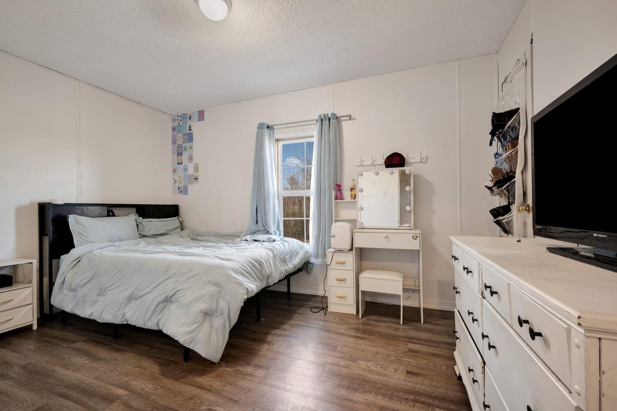 1169 Saddle Tree Road Ashland City, TN 37015 - Photo 19 of 29 a bedroom with a bed and a flat tv screen on dresser