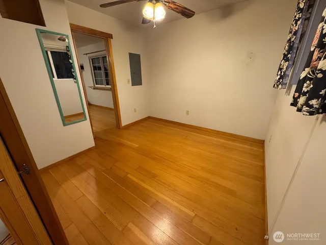 a view of a hallway with wooden floor