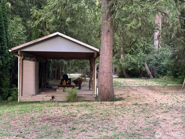 a view of a house with yard and sitting area