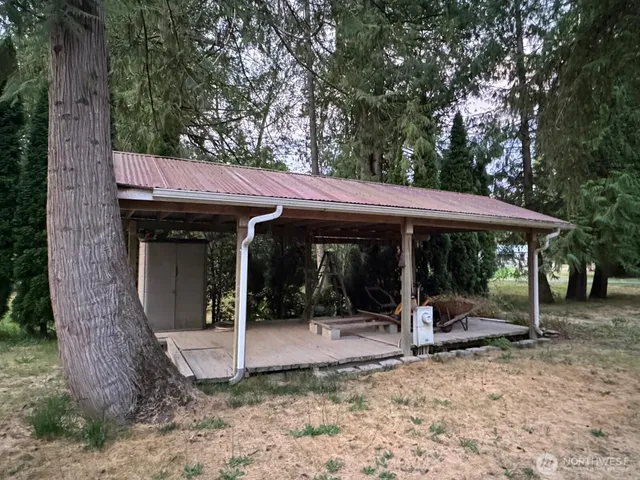 a view of a patio with a table and chairs under an umbrella