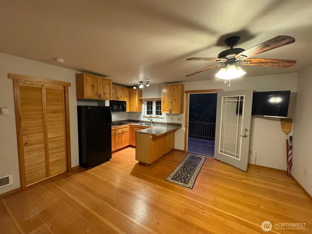 a kitchen with stainless steel appliances kitchen island granite countertop a refrigerator and a stove top oven