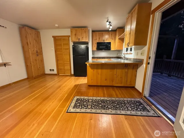 a kitchen with stainless steel appliances granite countertop a refrigerator stove and sink