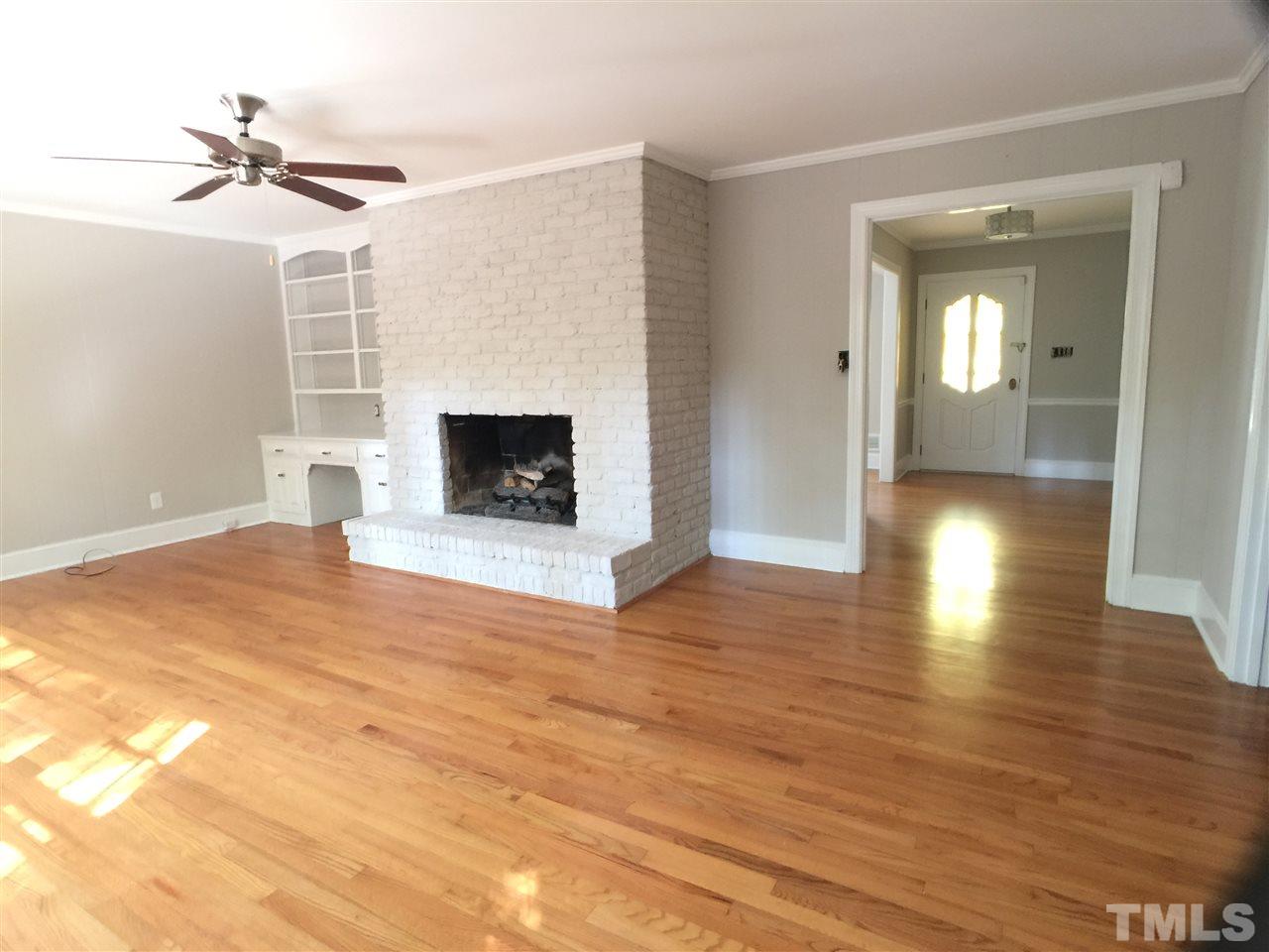 3105 Braddock Drive Raleigh, NC 27612 - Photo 11 of 19 a view of a livingroom with a fireplace and window