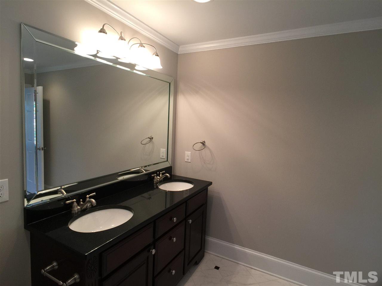 3105 Braddock Drive Raleigh, NC 27612 - Photo 13 of 19 a bathroom with a double vanity sink and a mirror