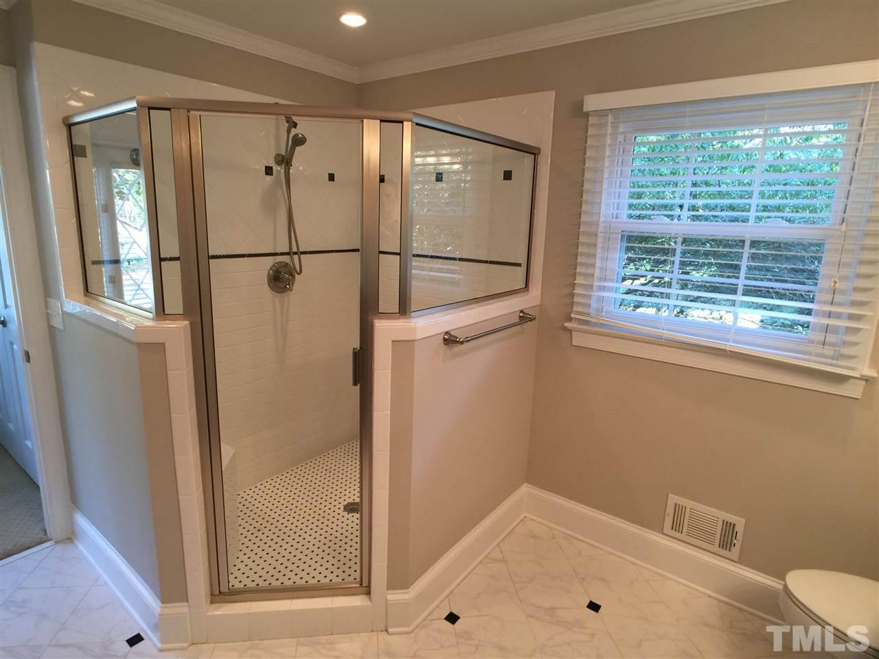 3105 Braddock Drive Raleigh, NC 27612 - Photo 14 of 19 a bathroom with a bathtub and a shower