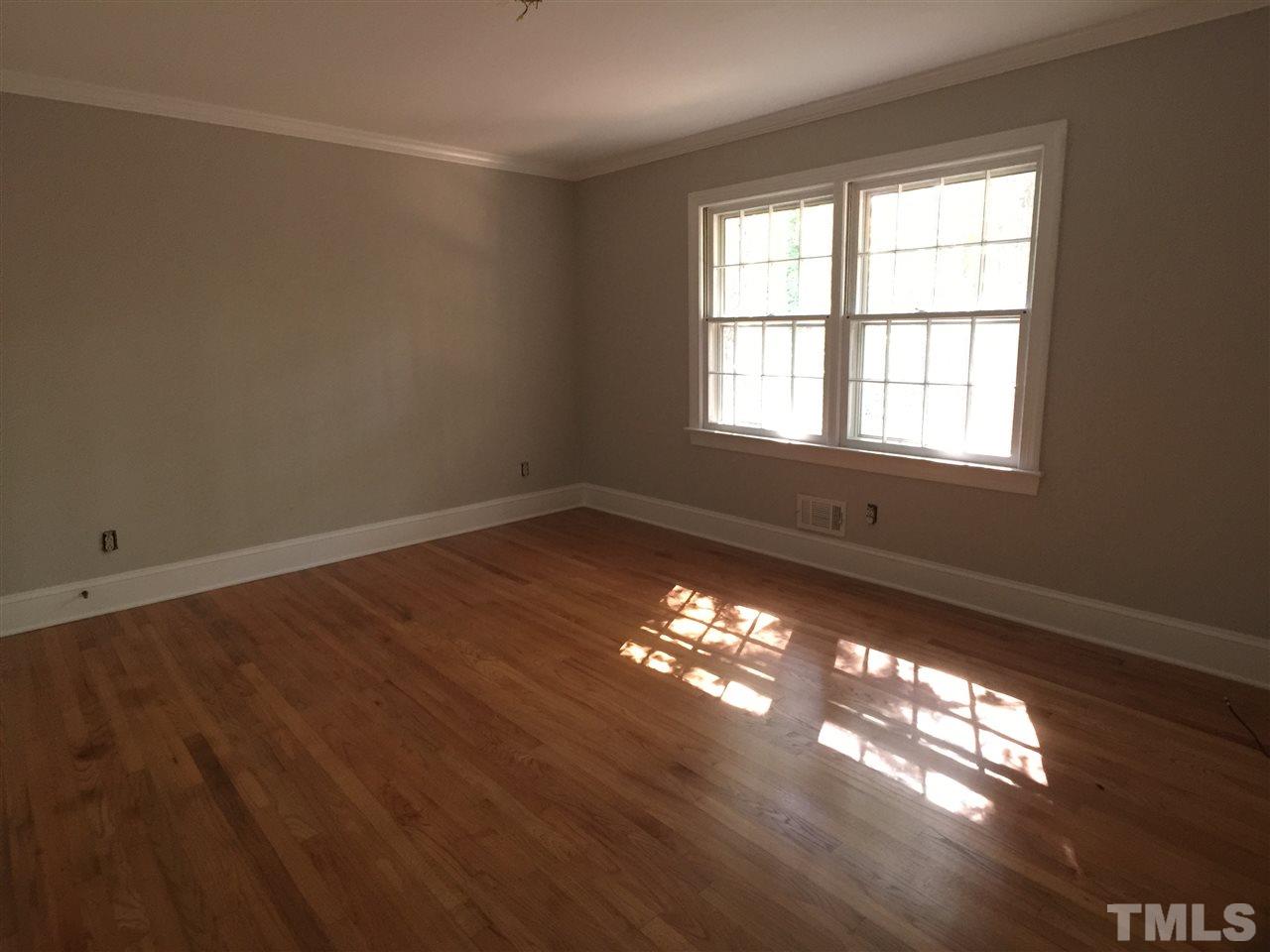 3105 Braddock Drive Raleigh, NC 27612 - Photo 16 of 19 a view of an empty room with window and chandelier fan