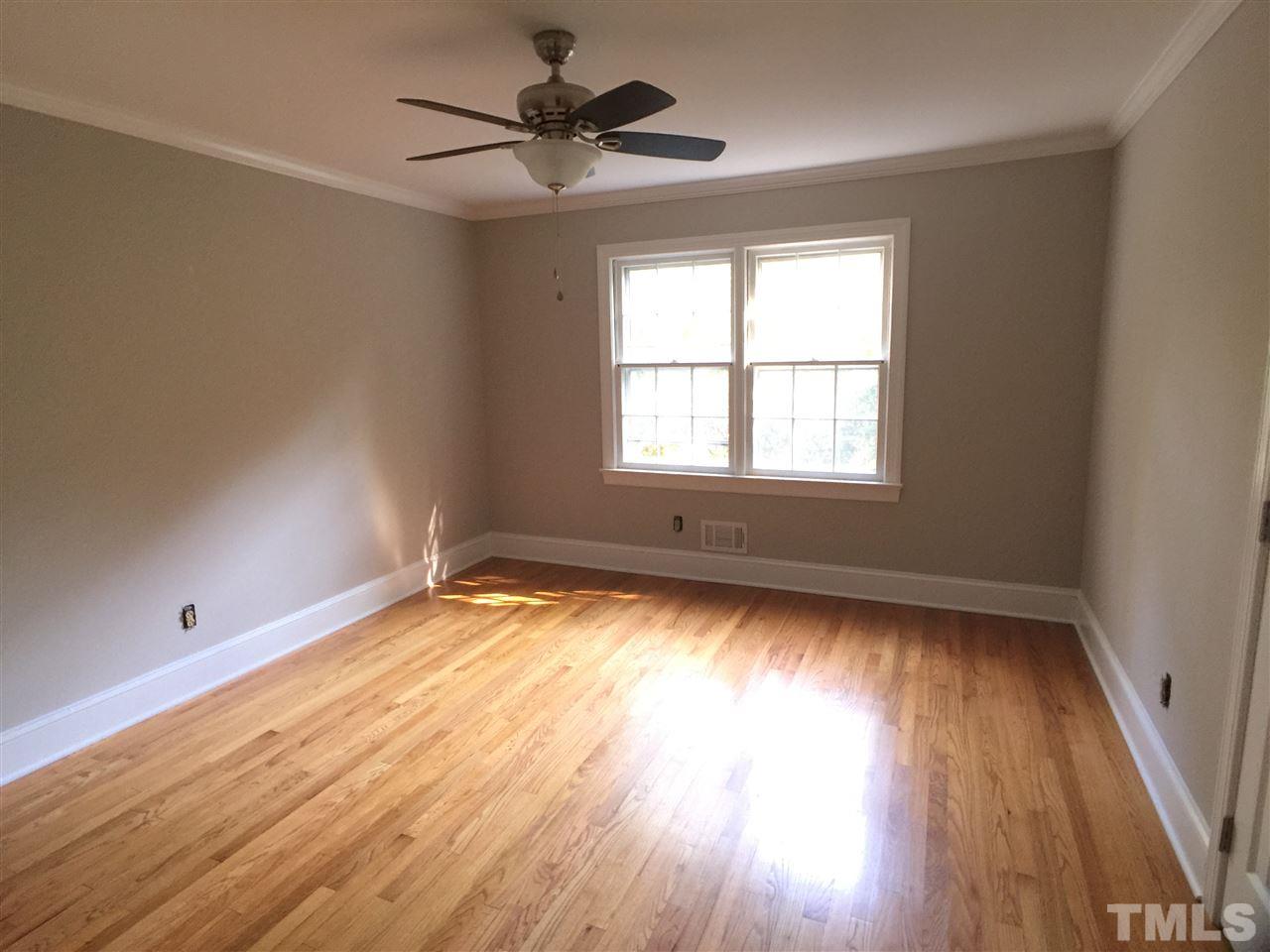 3105 Braddock Drive Raleigh, NC 27612 - Photo 17 of 19 an empty room with wooden floor and windows