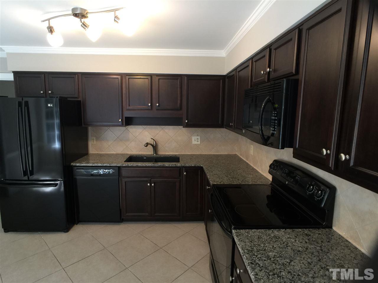 3105 Braddock Drive Raleigh, NC 27612 - Photo 9 of 19 a kitchen with a refrigerator and a sink