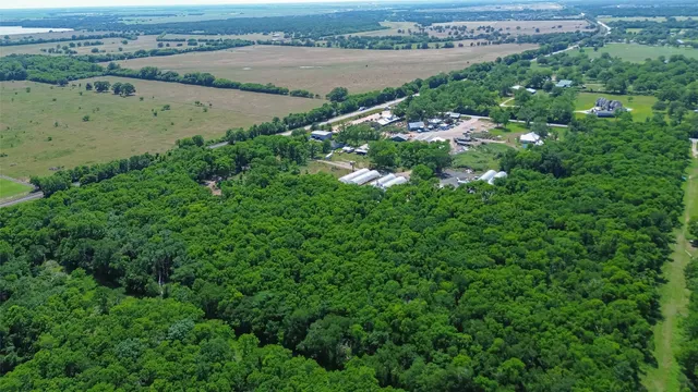 an aerial view of a houses with outdoor space and lake view