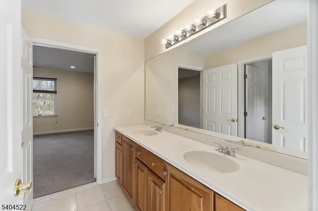 a view of house with backyard and trees in the background