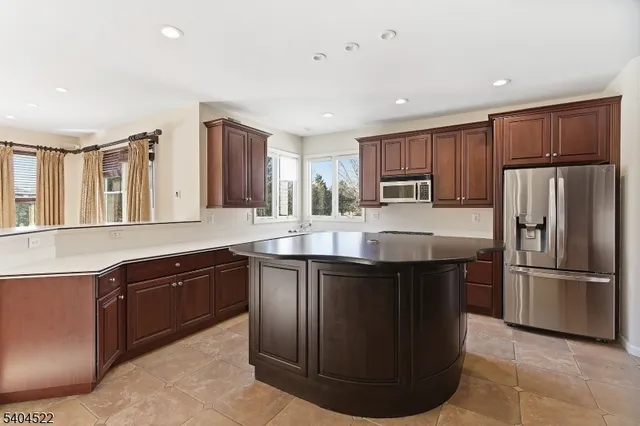 a kitchen with stainless steel appliances granite countertop a stove a sink dishwasher a refrigerator and a oven