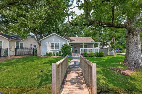 a front view of a house with yard patio and green space