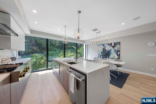 8824 Churchill Road North Bergen, NJ 07047 - Photo 39 of 50 a kitchen with stainless steel appliances a stove a sink a refrigerator a center island and couches