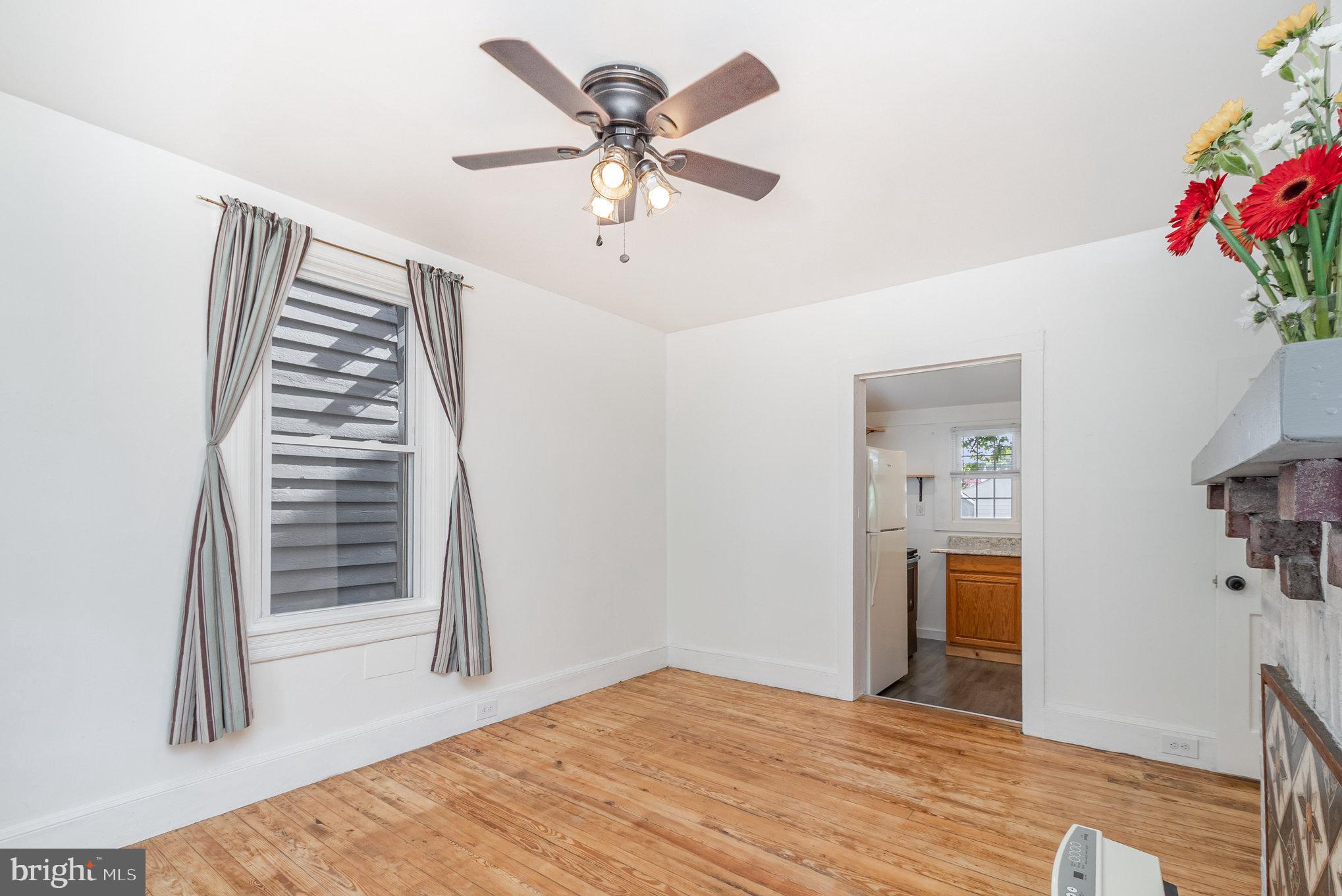 517 High Street Chestertown, MD 21620 - Photo 15 of 51 a bedroom with a bed and a chandelier