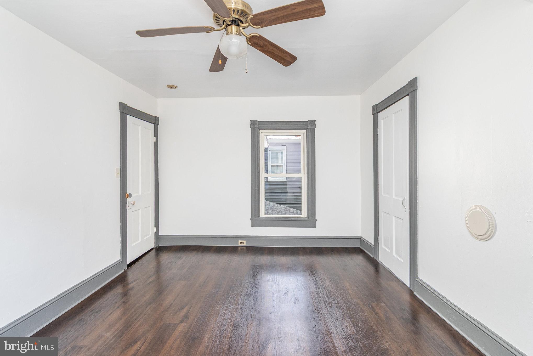 517 High Street Chestertown, MD 21620 - Photo 27 of 51 an empty room with wooden floor fan and windows