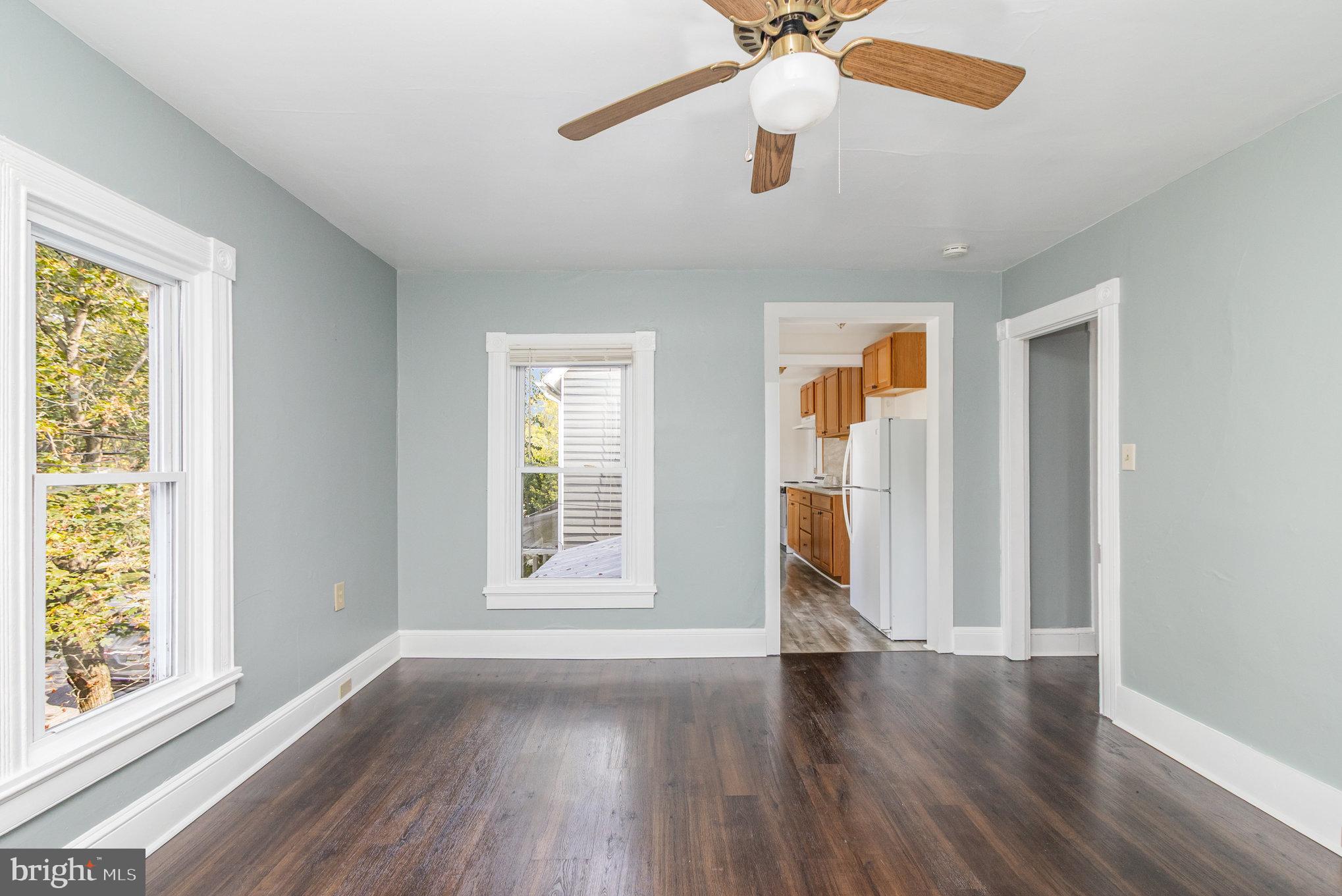 517 High Street Chestertown, MD 21620 - Photo 30 of 51 an empty room with wooden floor chandelier fan and windows