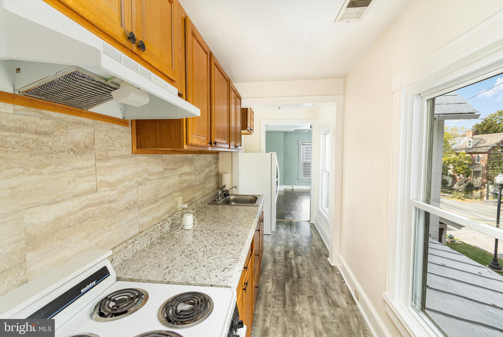 517 High Street Chestertown, MD 21620 - Photo 32 of 51 a bathroom with a granite countertop sink and a shower