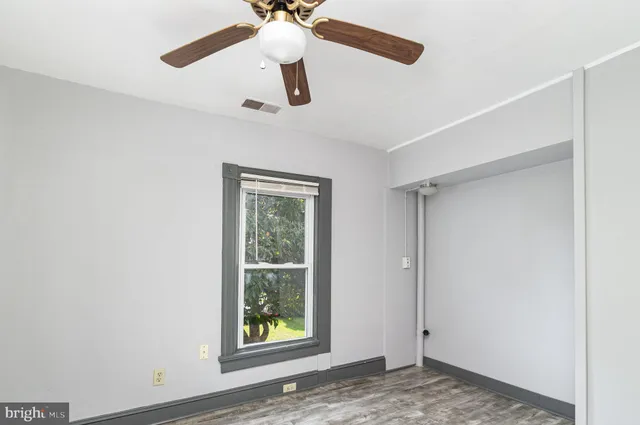 a view of a livingroom with a ceiling fan and window