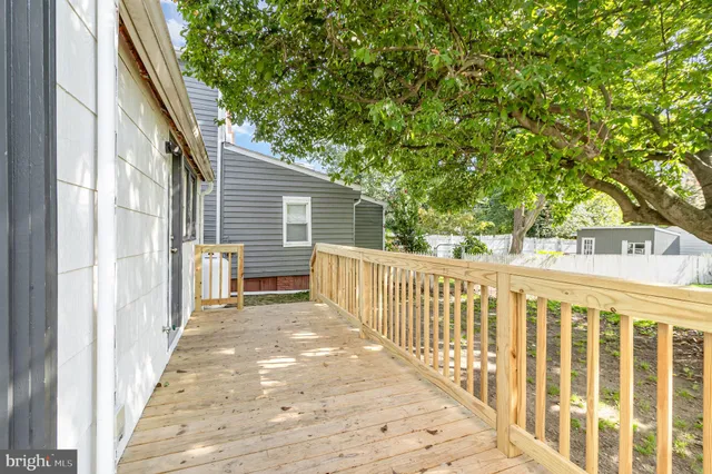a view of a house with wooden fence
