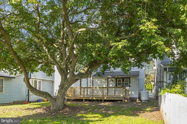 an aerial view of a house with a yard and outdoor seating