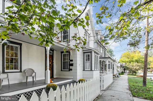 a front view of a house with outdoor seating