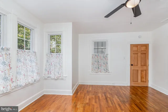 a view of an empty room with a fireplace and a window