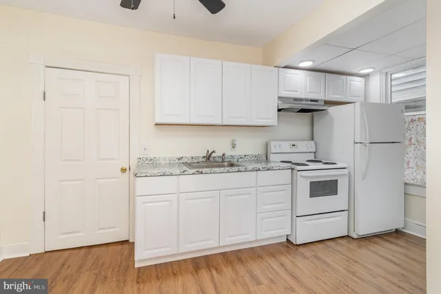 a kitchen with a sink and cabinets