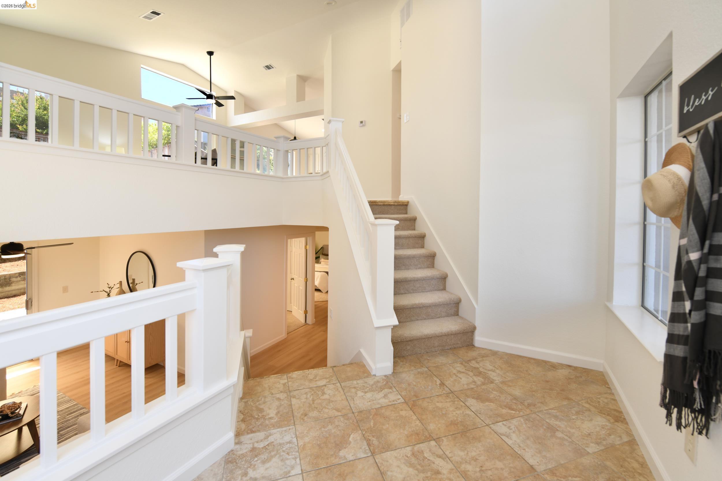 512 Burdick Drive Bay Point, CA 94565 - Photo 9 of 50 Foyer with tile flooring, staircase with carpeted treads and white railings, and a window with gridded panes