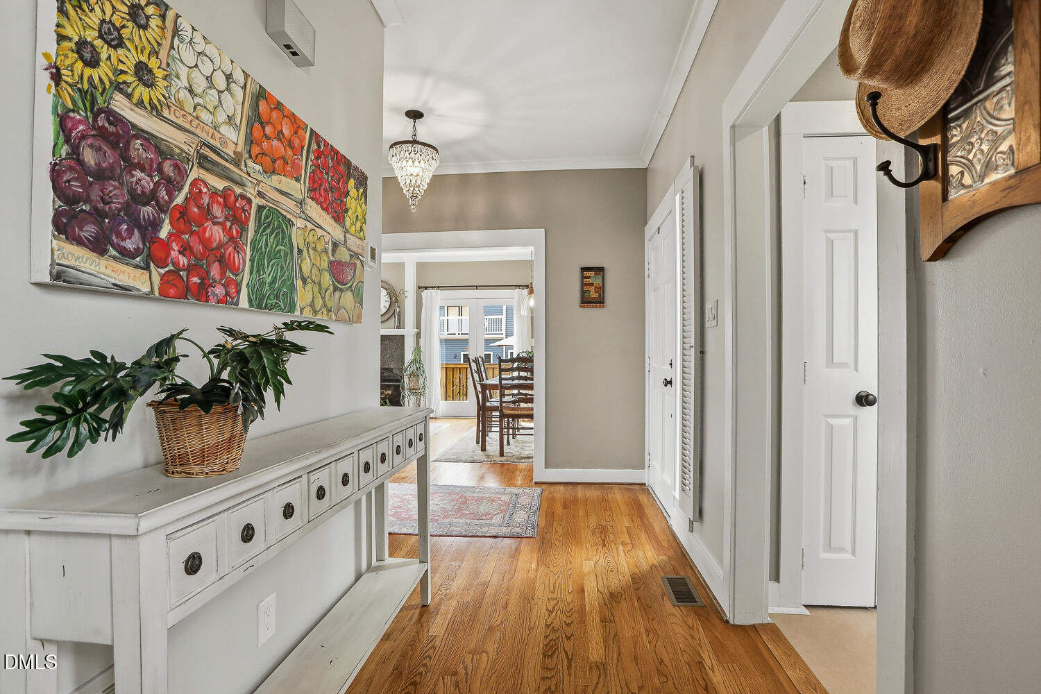 6023 Sentinel Drive Raleigh, NC 27609 - Photo 4 of 53 a hallway with painting and wooden floor