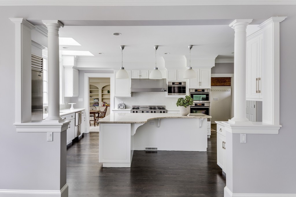18 Meadowbrook Road Weston, MA 02493 - Photo 18 of 29 a kitchen with stainless steel appliances granite countertop a refrigerator a stove and white cabinets with wooden floor