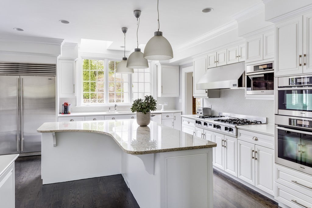18 Meadowbrook Road Weston, MA 02493 - Photo 19 of 29 a kitchen with stainless steel appliances granite countertop a sink stove and refrigerator