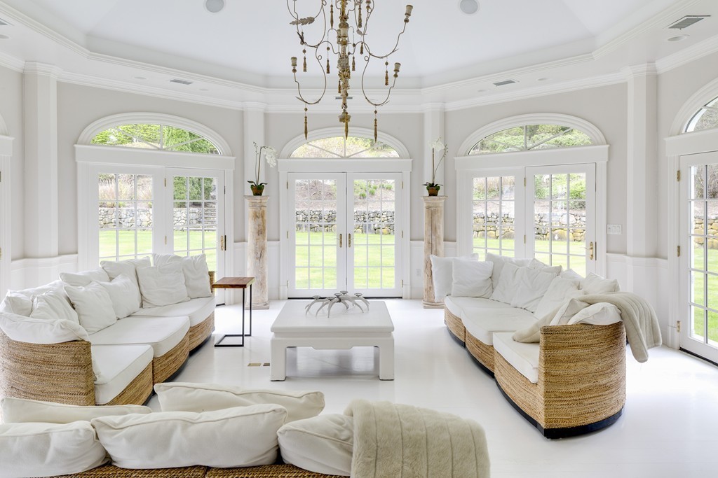18 Meadowbrook Road Weston, MA 02493 - Photo 26 of 29 a living room with couches a table and a chandelier