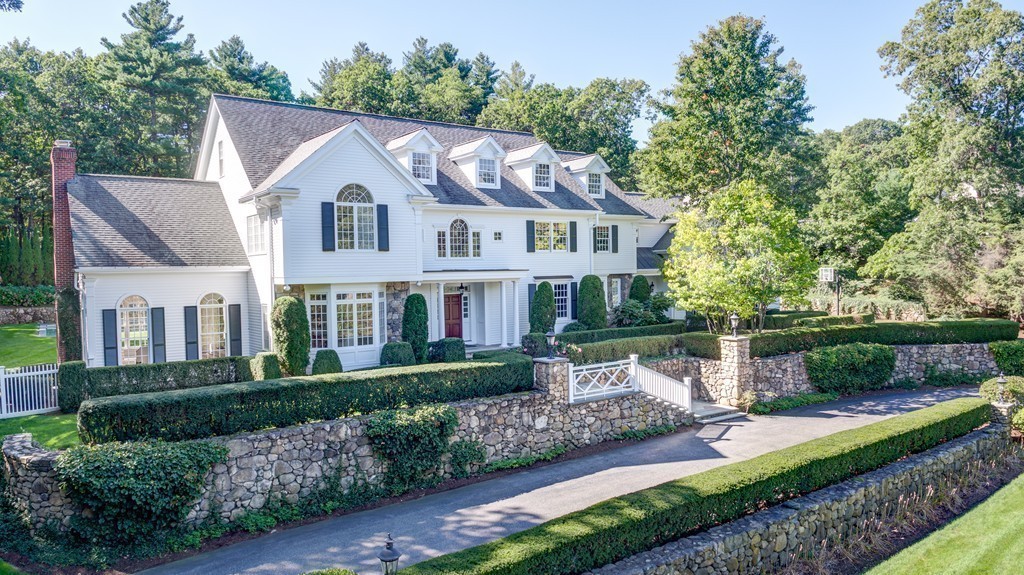 18 Meadowbrook Road Weston, MA 02493 - Photo 6 of 29 a front view of a house with a garden and plants