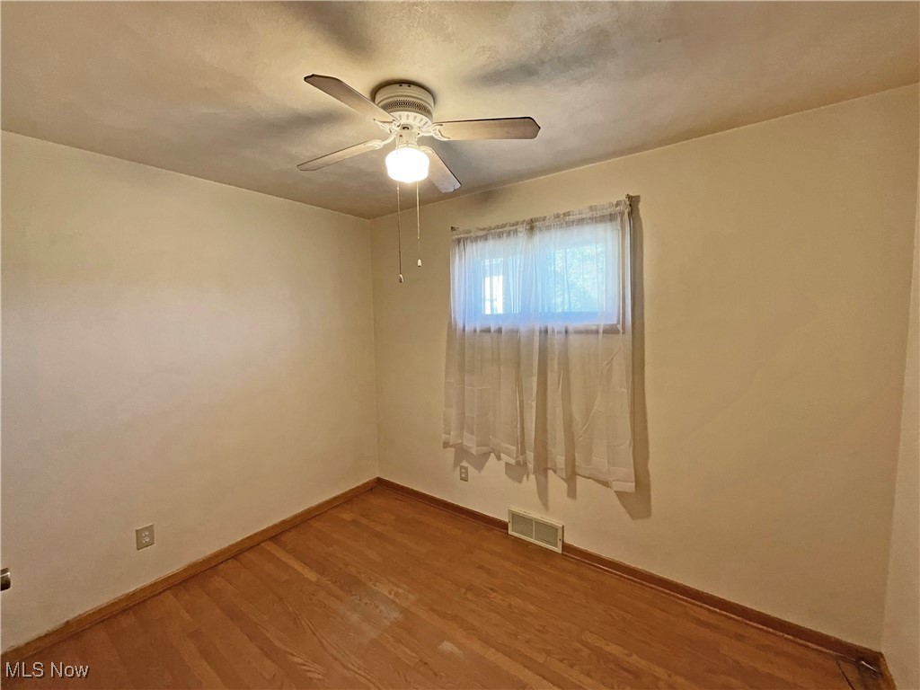 106 Ridgeway Avenue Weirton, WV 26062 - Photo 8 of 19 Empty room featuring hardwood / wood-style floors and ceiling fan
