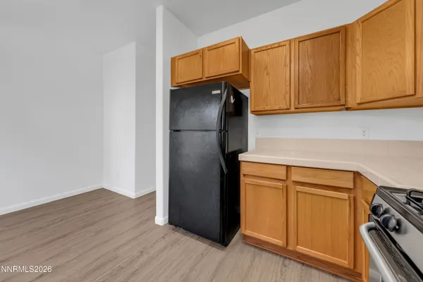 a kitchen with a refrigerator and cabinets