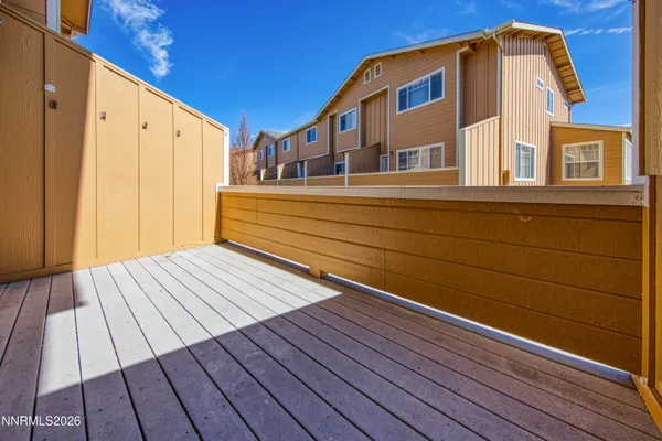 a view of balcony with wooden floor and fence
