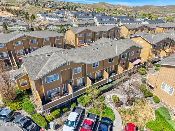 an aerial view of residential houses with outdoor space