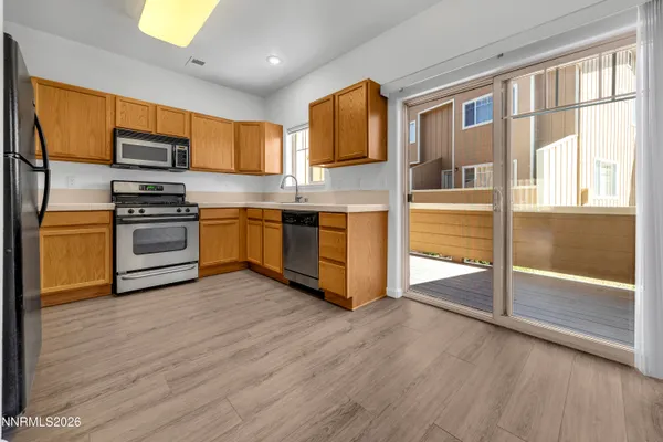 a kitchen with stainless steel appliances granite countertop a stove and a refrigerator