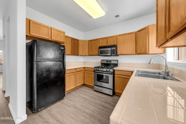 a kitchen with a refrigerator stove and a sink