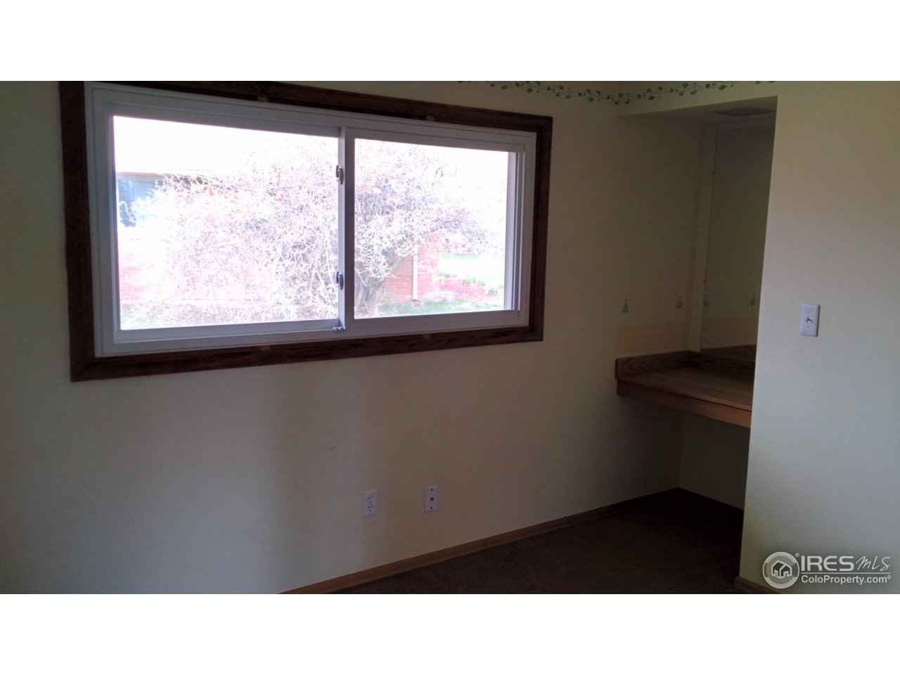 2478 25th Street Road Greeley, CO 80634 - Photo 11 of 19 a black and white photo of a living room